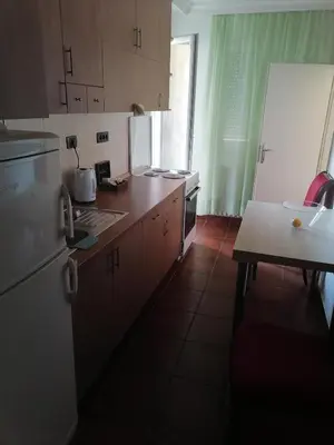 a kitchen with a white refrigerator and a table at Andreja apartman 2 (jednosobni app -50m2) in Belgrade