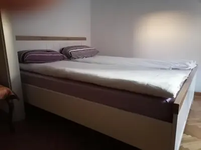 a bed with two pillows on top of it at Andreja apartman 2 (jednosobni app -50m2) in Belgrade