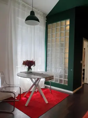 a table and a chair in a room with a window at Studio Apartment 