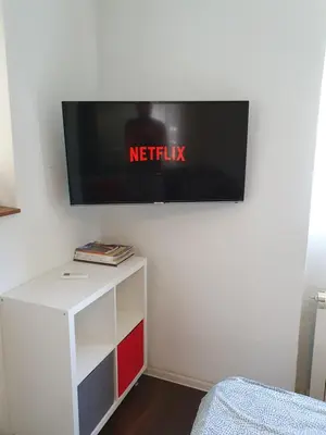 a flat screen tv hanging on a wall at Studio Apartment 
