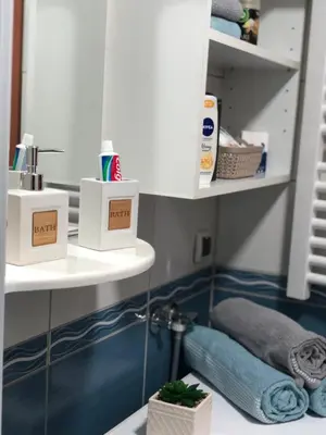 a bathroom with a sink and a mirror and towels at BellaVista Apartmani in Stara Pazova