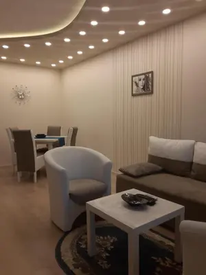 a living room with a couch and chairs and a table at Danube Blue 2 in Belgrade