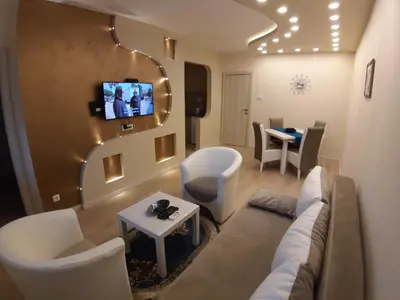 a living room with a couch and a tv on the wall at Danube Blue 2 in Belgrade