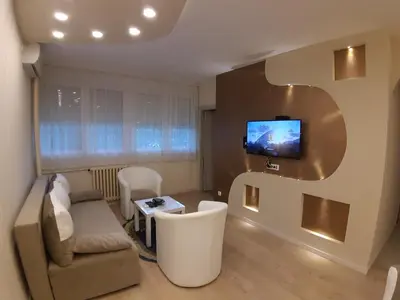 a living room with a couch and a tv on the wall at Danube Blue 2 in Belgrade