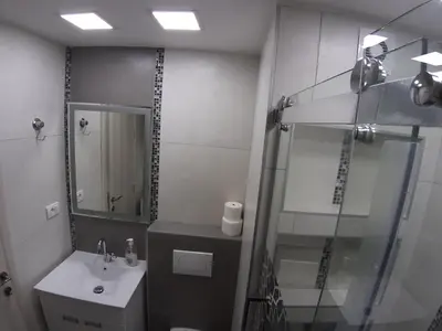 a bathroom with a glass shower and a sink at Danube Blue 2 in Belgrade