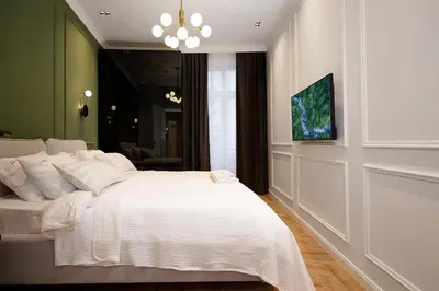 a bedroom with a white bed and a chandelier at Luxury Apartments Donostia & Iruña in Belgrade