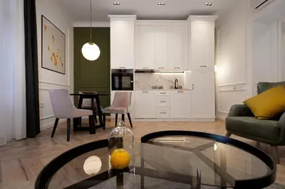 a living room with a table and a kitchen at Luxury Apartments Donostia & Iruña in Belgrade