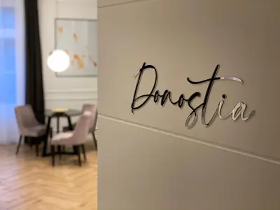 a sign on a wall in a room with a table at Luxury Apartments Donostia & Iruña in Belgrade