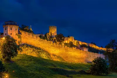 a castle on a hill at night at Belvedere Skadarska Apartment in Belgrade