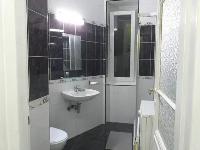 a small bathroom with a sink and a toilet at Belvedere Skadarska Apartment in Belgrade