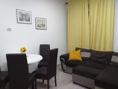 a living room with a couch and a table at Belvedere Skadarska Apartment in Belgrade