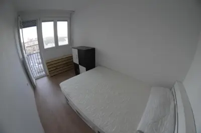 a white bedroom with a bed and a window at Apartment Dorcol in Belgrade