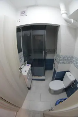 a bathroom with a shower and a toilet and a sink at Apartment Dorcol in Belgrade