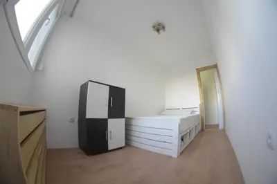 a room with a black and white refrigerator and dressers at Apartment Dorcol in Belgrade
