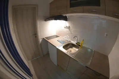 a kitchen with a sink with a light above it at Apartment Dorcol in Belgrade