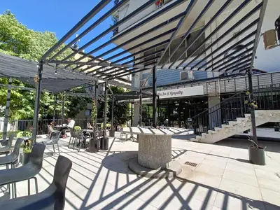 a patio with chairs and tables in front of a building at Apartment Dorcol in Belgrade