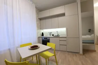 a kitchen with a white table and yellow chairs at Belgrade Center Apartment VI in Belgrade