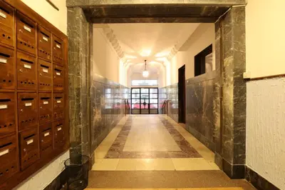 a hallway in a building with wooden lockers at Belgrade Center Apartment VI in Belgrade