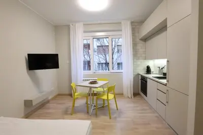 a kitchen with a table and yellow chairs in a room at Belgrade Center Apartment VI in Belgrade