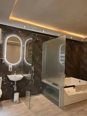 a bathroom with a shower and a sink and mirror at Kengur Resort in Belgrade
