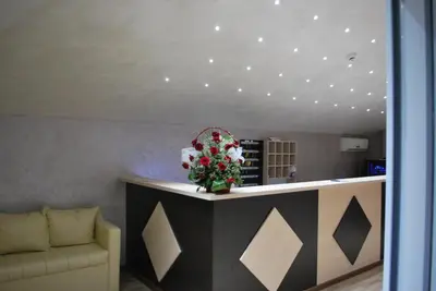 a lobby with a flower arrangement on a counter at Kengur Resort in Belgrade