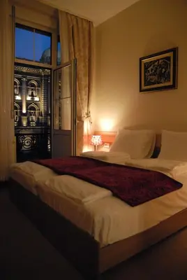 a large bed in a bedroom with a window at Apartments Legacy in Belgrade