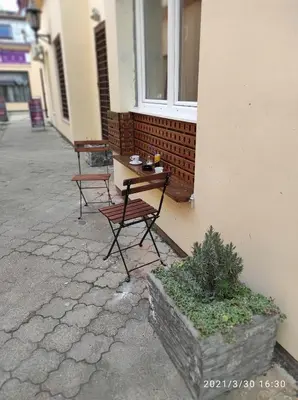 a table and chairs sitting outside of a building at Retro Mini Apartment in Zemun