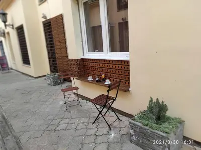a table and chairs sitting outside of a building at Retro Mini Apartment in Zemun