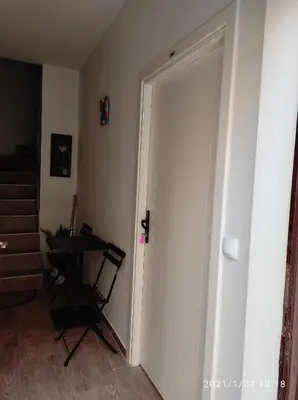 a door leading into a room with a table at Retro Mini Apartment in Zemun