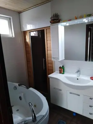 a bathroom with a tub and a sink and a mirror at Vila Ana in Donja Ralja