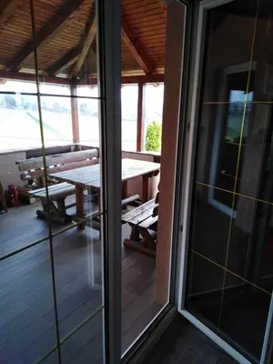 a screened in porch with a table and a picnic table at Vila Ana in Donja Ralja