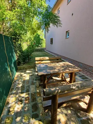 a wooden picnic table sitting next to a building at Vila Ana in Donja Ralja