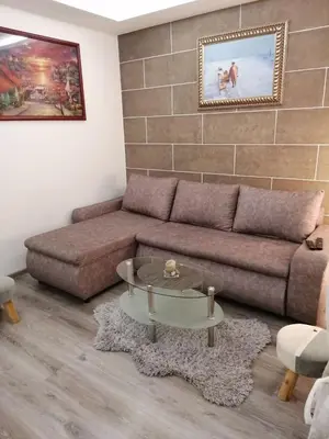 a living room with a couch and a table at DEP House in Zemun