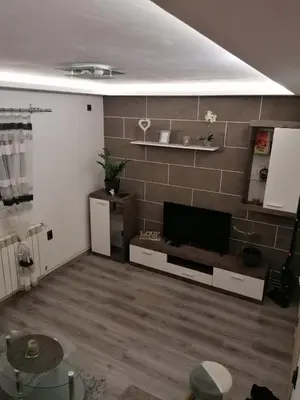 a living room with a flat screen tv on a wall at DEP House in Zemun