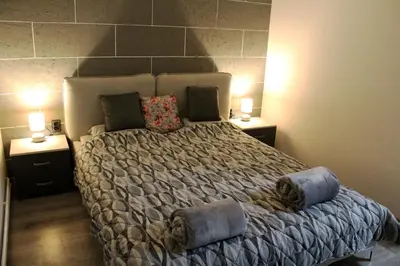 a bedroom with a large bed with two night stands at DEP House in Zemun