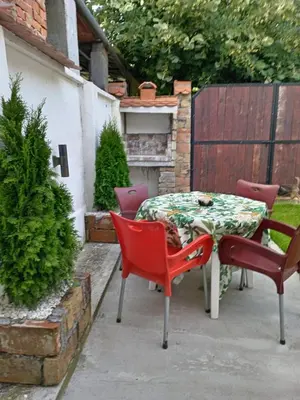 a patio with a table and chairs on a patio at DEP House in Zemun