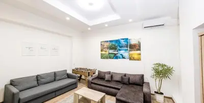 a living room with a couch and a table at 4Seasons in Sajmište