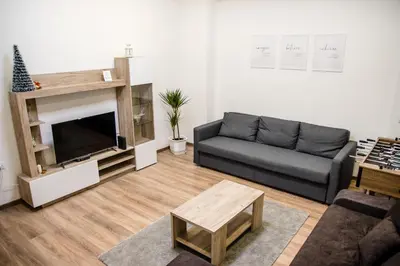 a living room with a couch and a television at 4Seasons in Sajmište