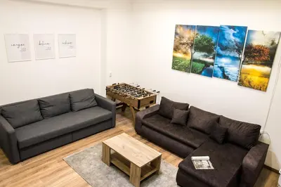 a living room with two couches and a table at 4Seasons in Sajmište