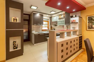 a kitchen with brown cabinets and a red ceiling at Villa Wisteria in Smederevo