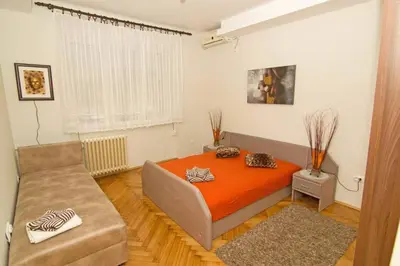 a bedroom with a bed and a couch in it at See U in Belgrade in Belgrade