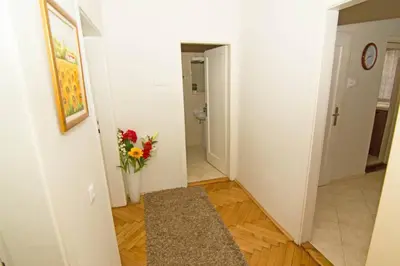 a hallway with a vase of flowers in a room at See U in Belgrade in Belgrade