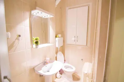 a bathroom with a white toilet and a sink at See U in Belgrade in Belgrade