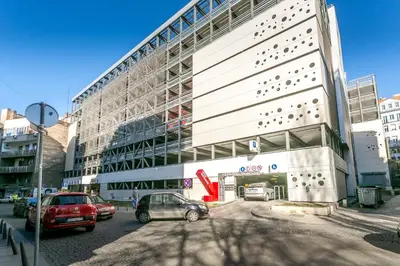 a building with cars parked in front of it at Apartment Marsal in Belgrade