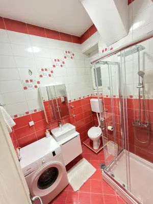 a bathroom with a washing machine and a toilet at Apartment Marsal in Belgrade