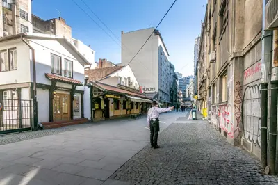 a man walking down a street in a city at Apartment Marsal in Belgrade