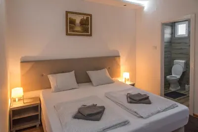 a bedroom with a bed with two pillows on it at APARTMAN TEA in Belgrade