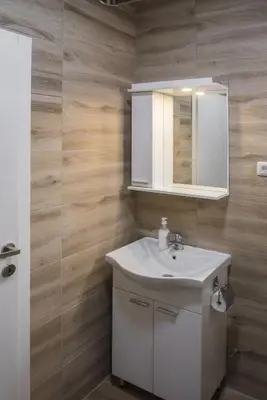 a bathroom with a white sink and a mirror at APARTMAN TEA in Belgrade