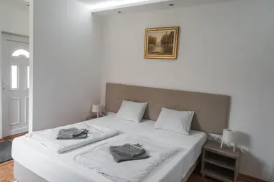 a bedroom with a bed with two pillows on it at APARTMAN TEA in Belgrade