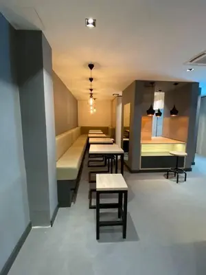 a row of tables and benches in a room at Super seven inn in Belgrade